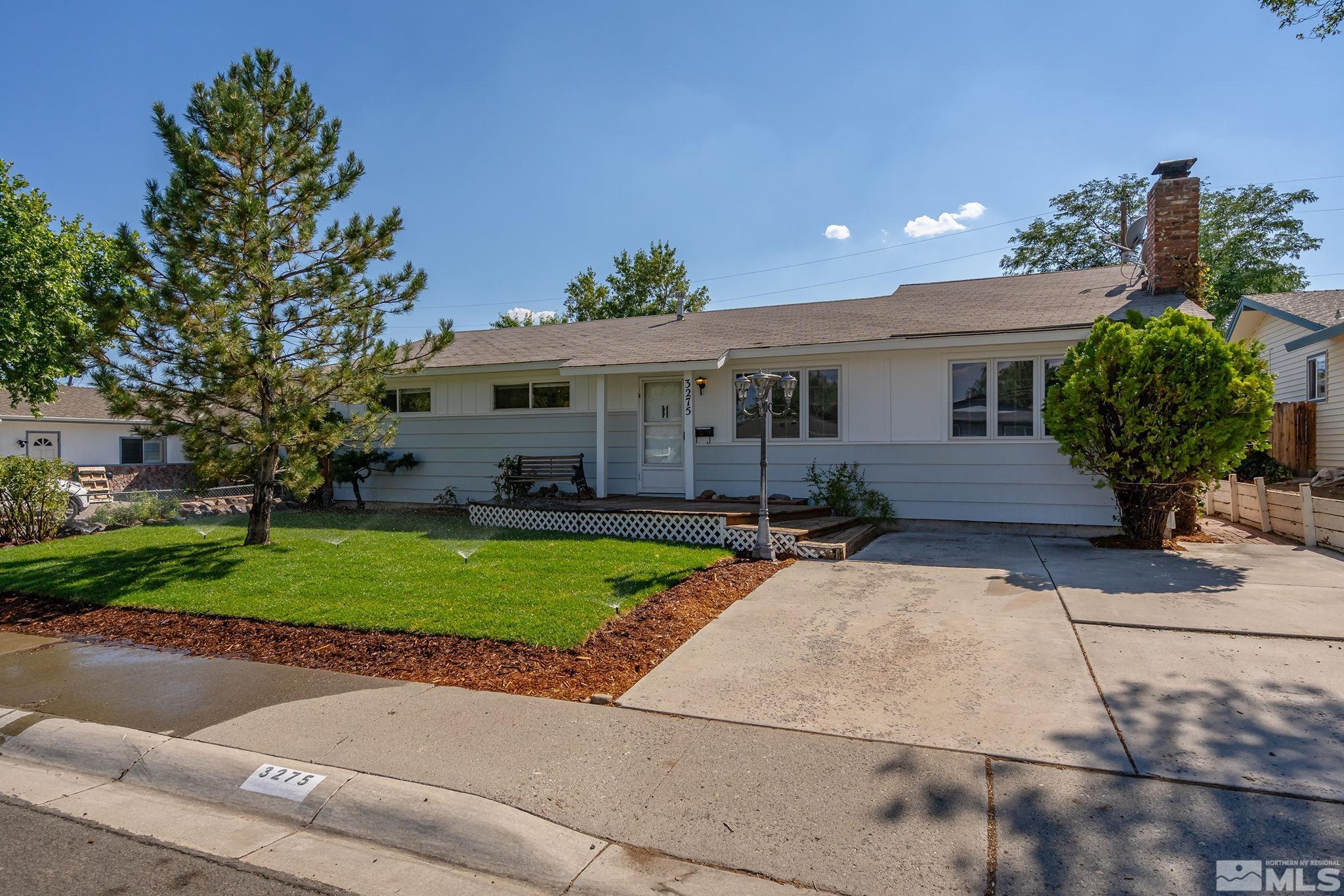 a front view of a house with a yard and a garage