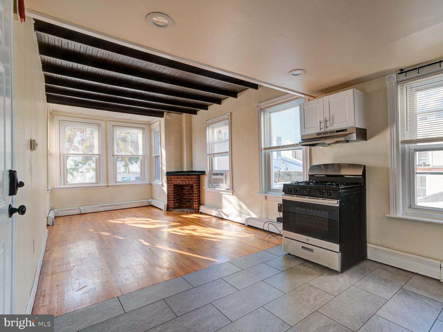 a view of kitchen with granite countertop a stove top oven a sink and a window