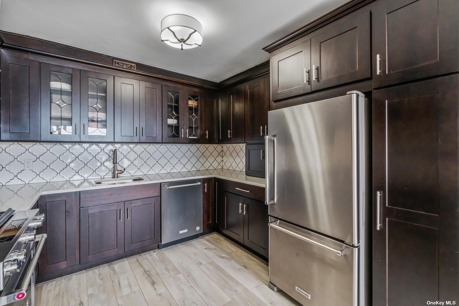 a kitchen with stainless steel appliances granite countertop a refrigerator and a sink