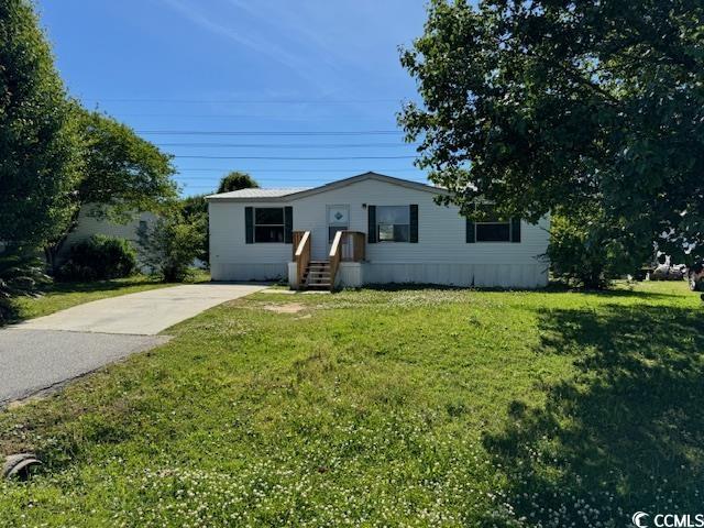 Ranch-style home with a front lawn