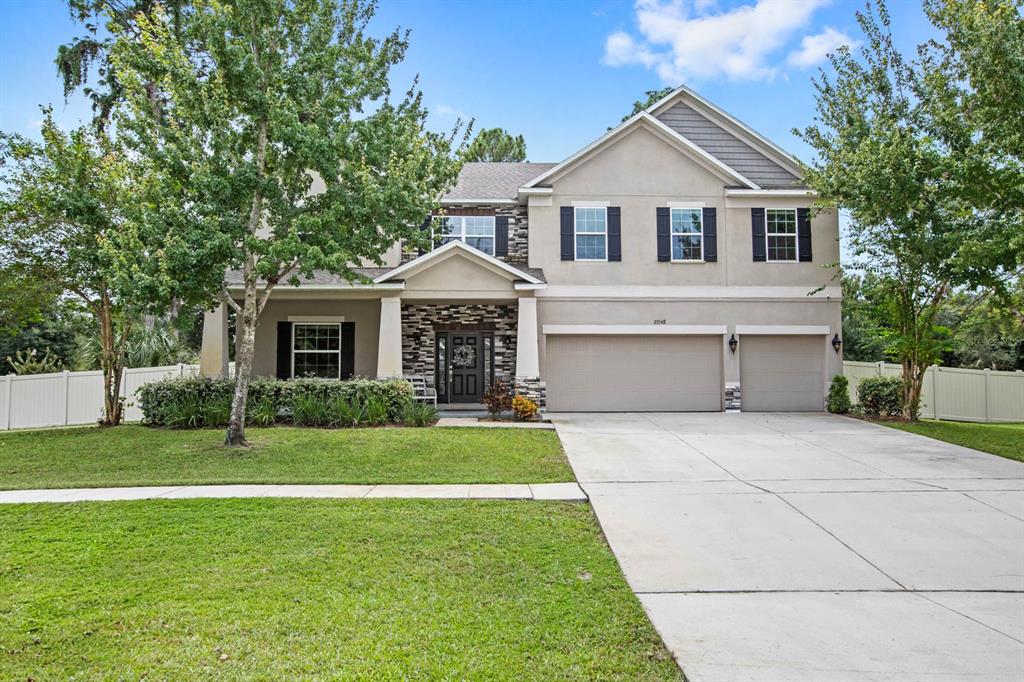 a front view of a house with a yard and garage