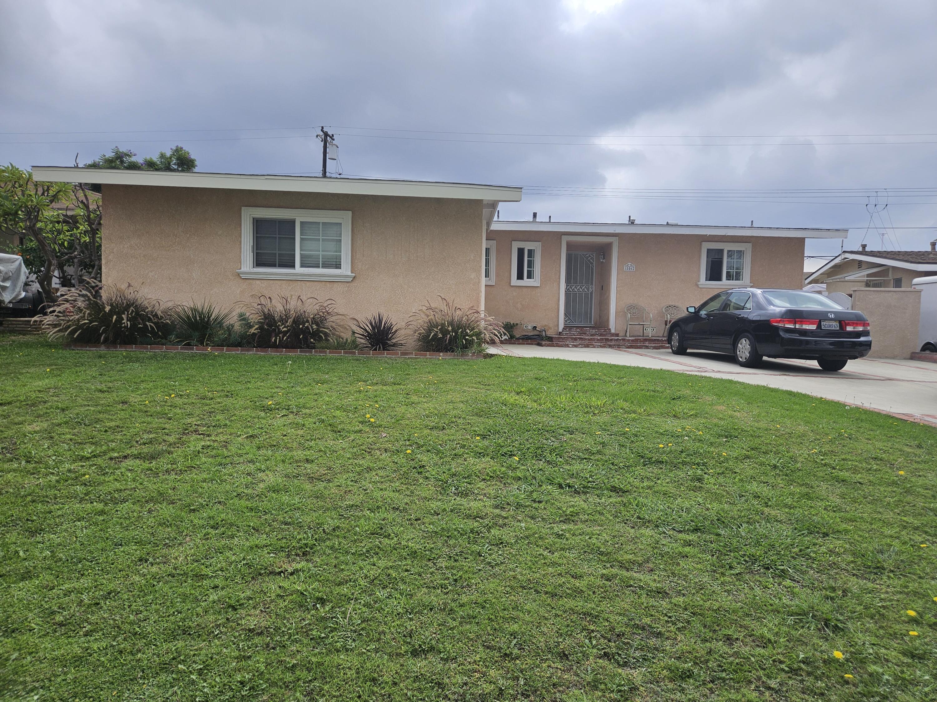 a front view of a house with a garden