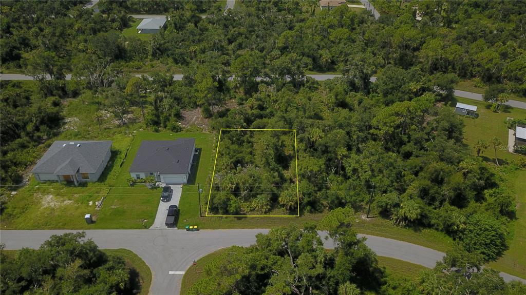 an aerial view of a house with a yard