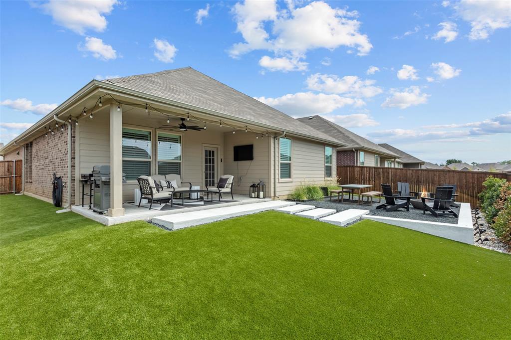 a view of a house with backyard porch and sitting area