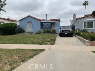 a front view of a house with a garden and patio