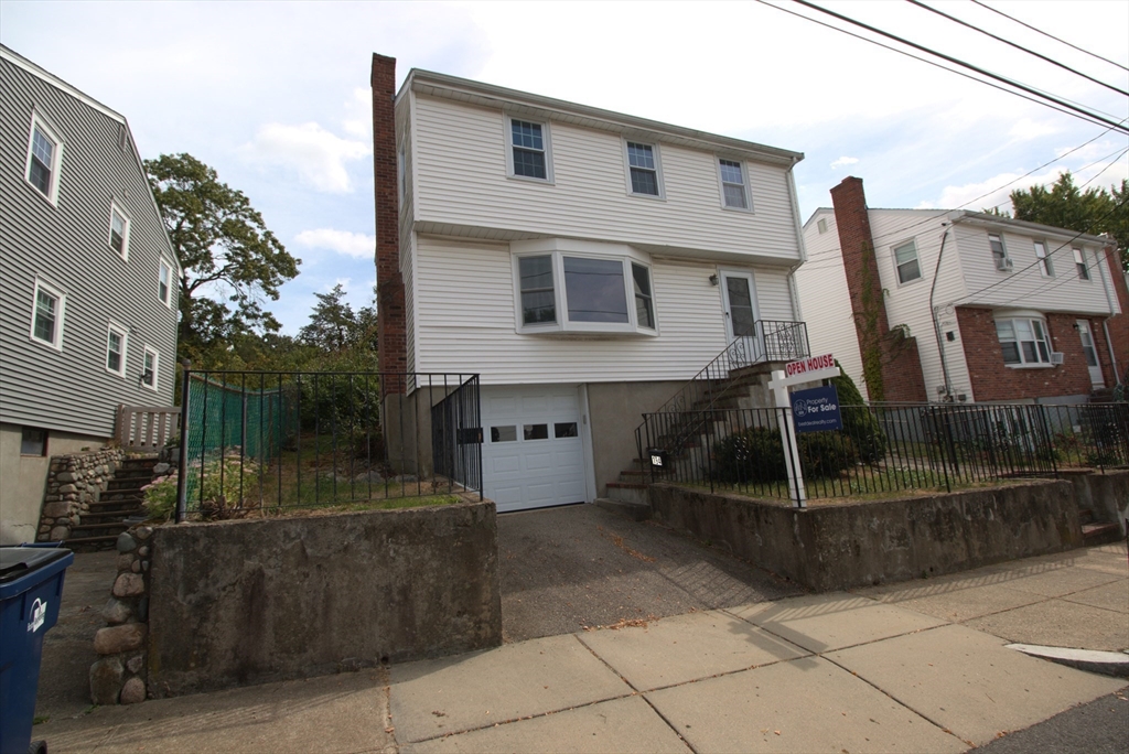 a front view of a house with iron fence