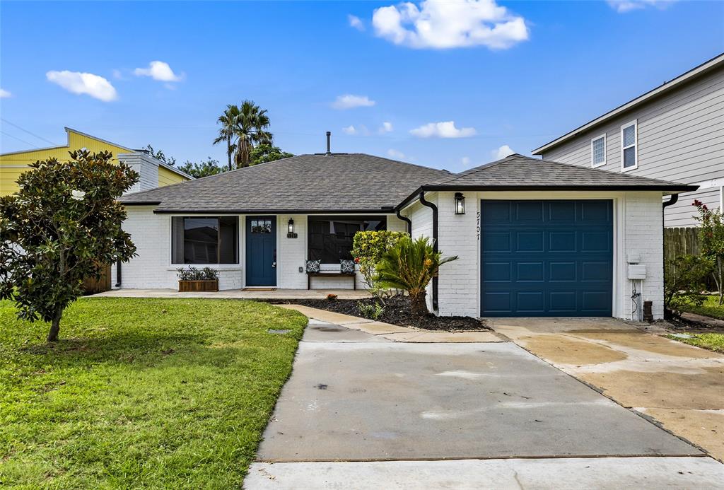 a front view of a house with yard and outdoor seating