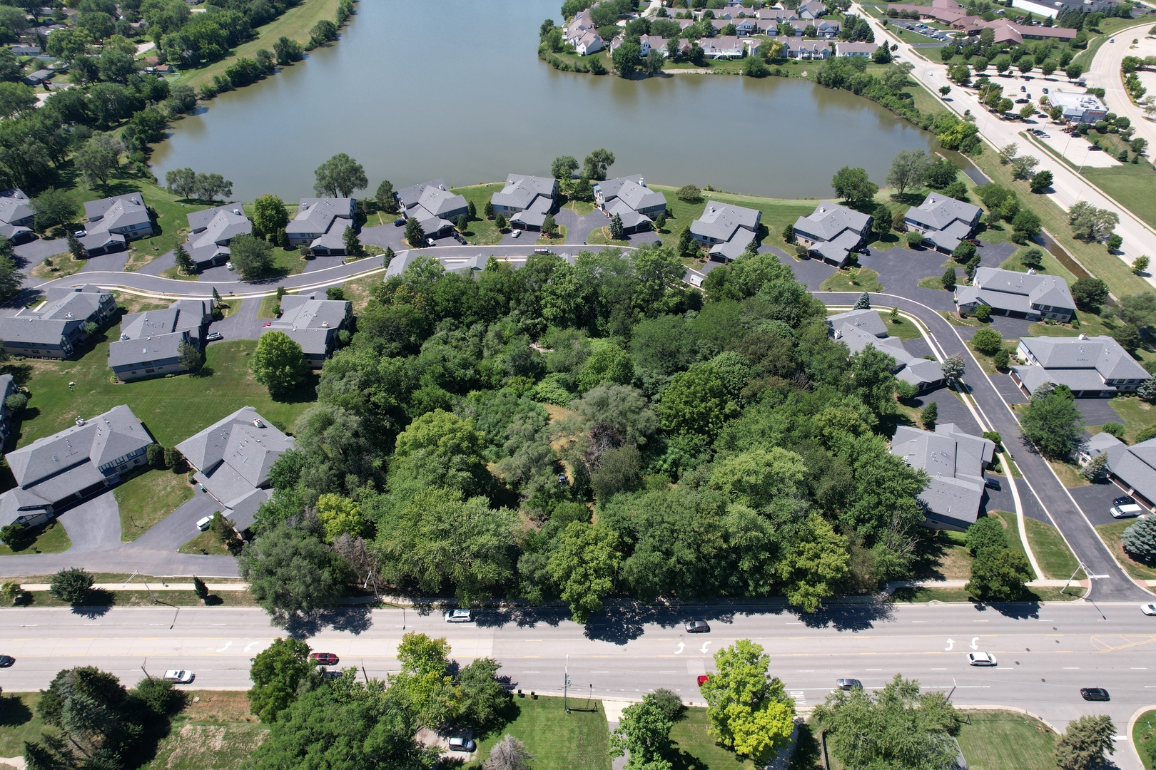 an aerial view of a house with outdoor space and lake view