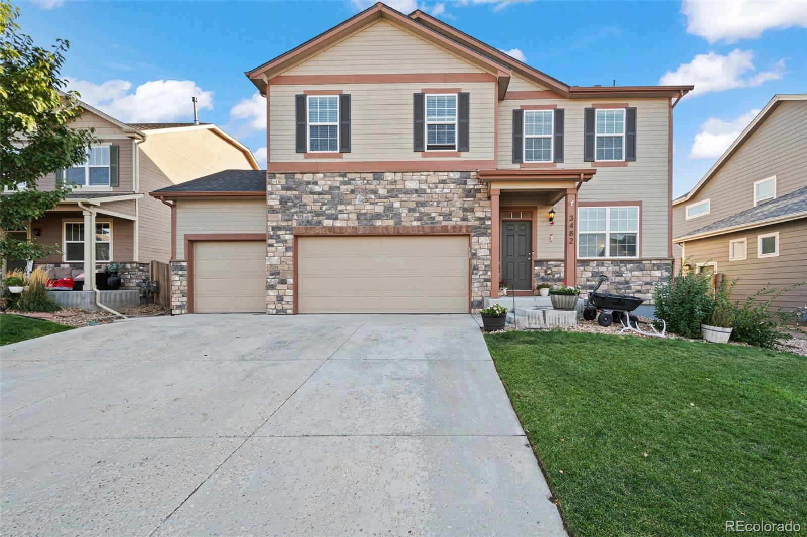 a front view of a house with a yard and garage