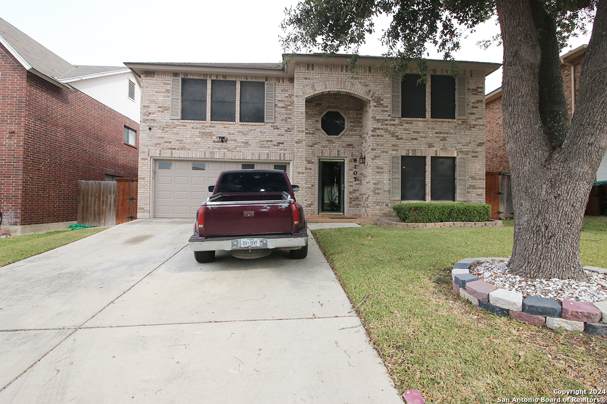 a car parked in front of a brick house