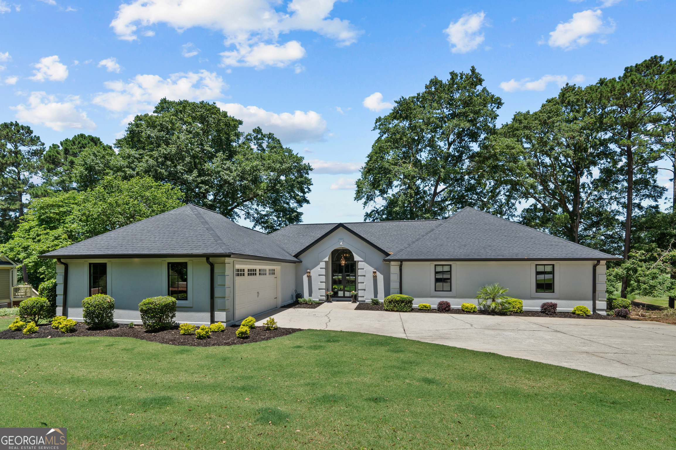 a front view of a house with a garden and porch