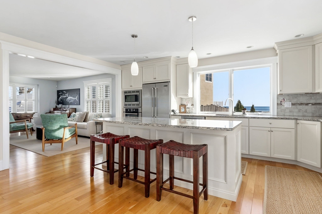 a kitchen with center island table and chairs in it