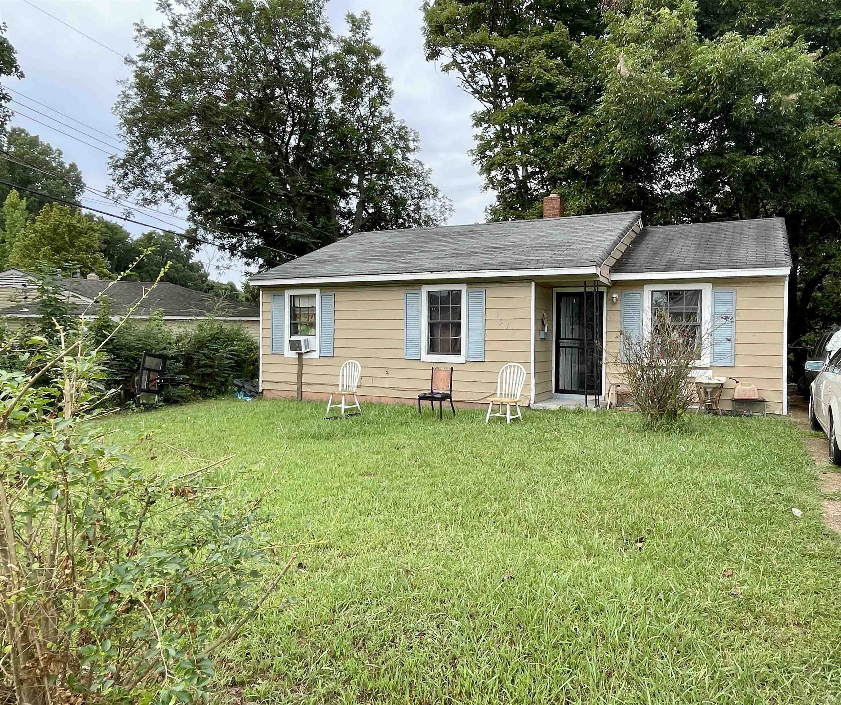 a front view of house with yard and green space