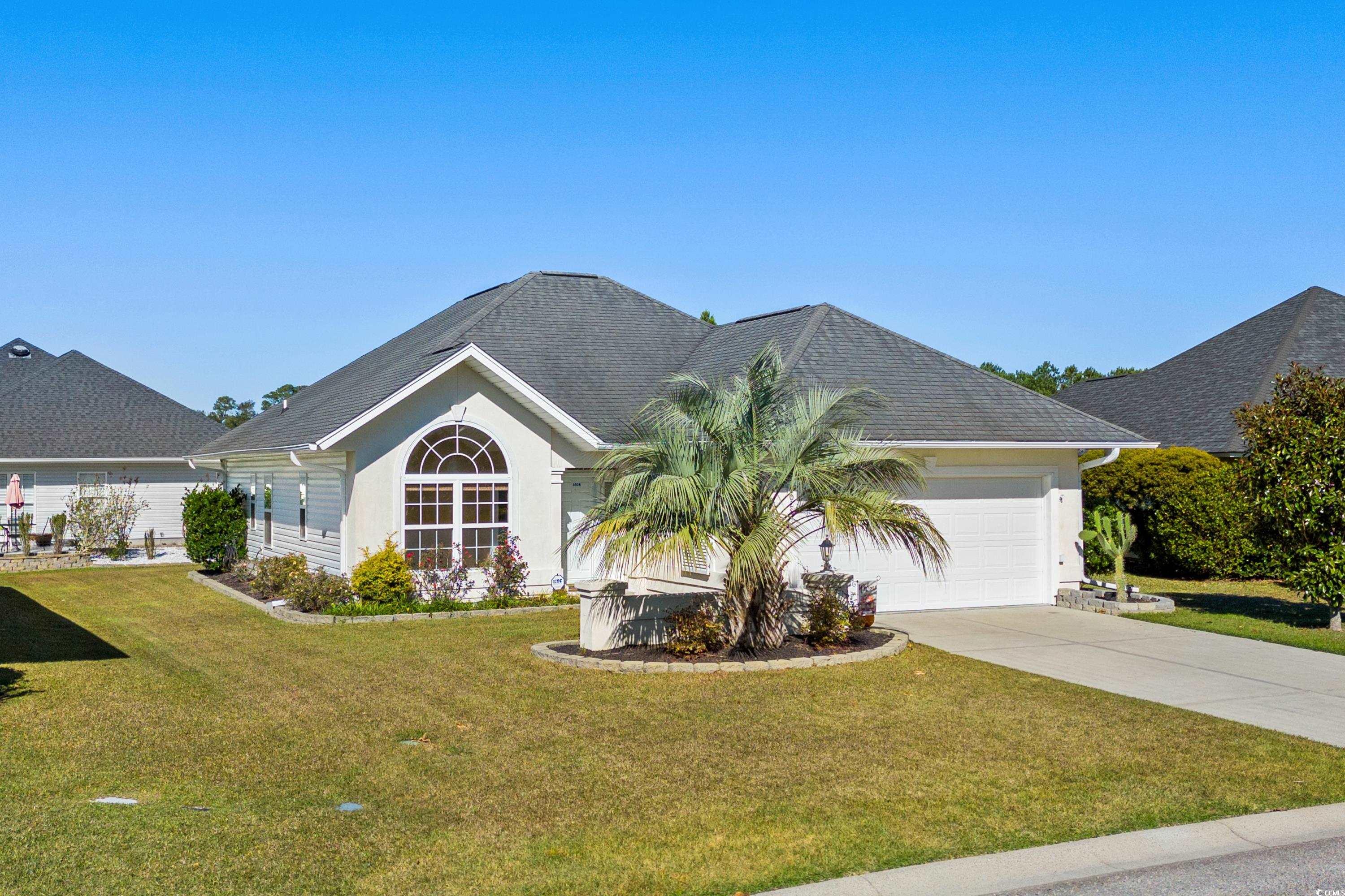 View of front facade featuring a garage and a fron