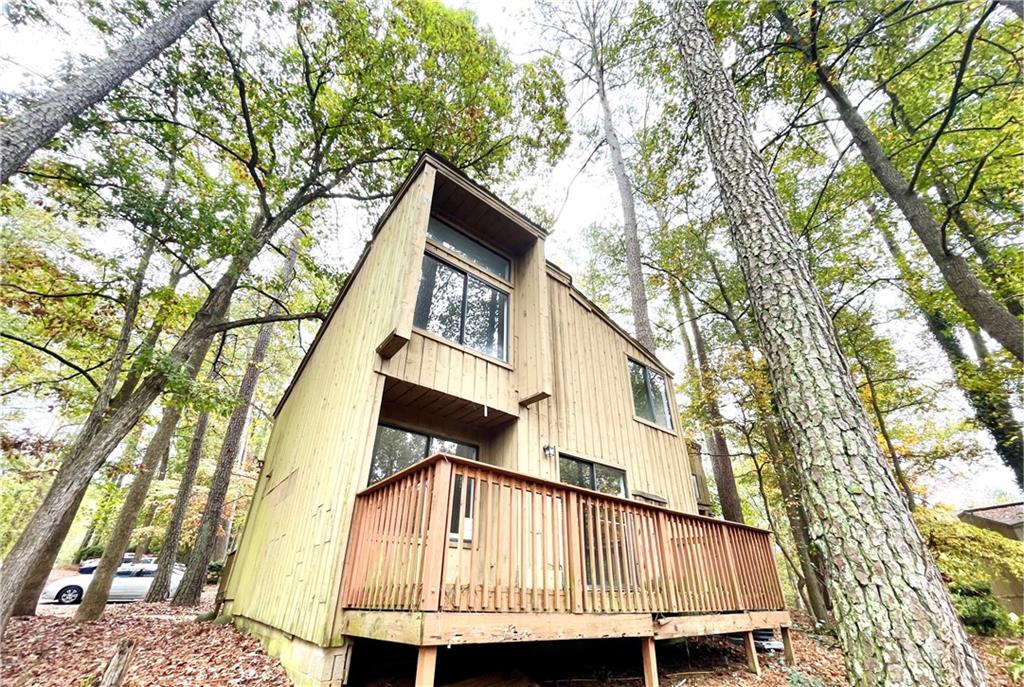 a front view of a house with a tree