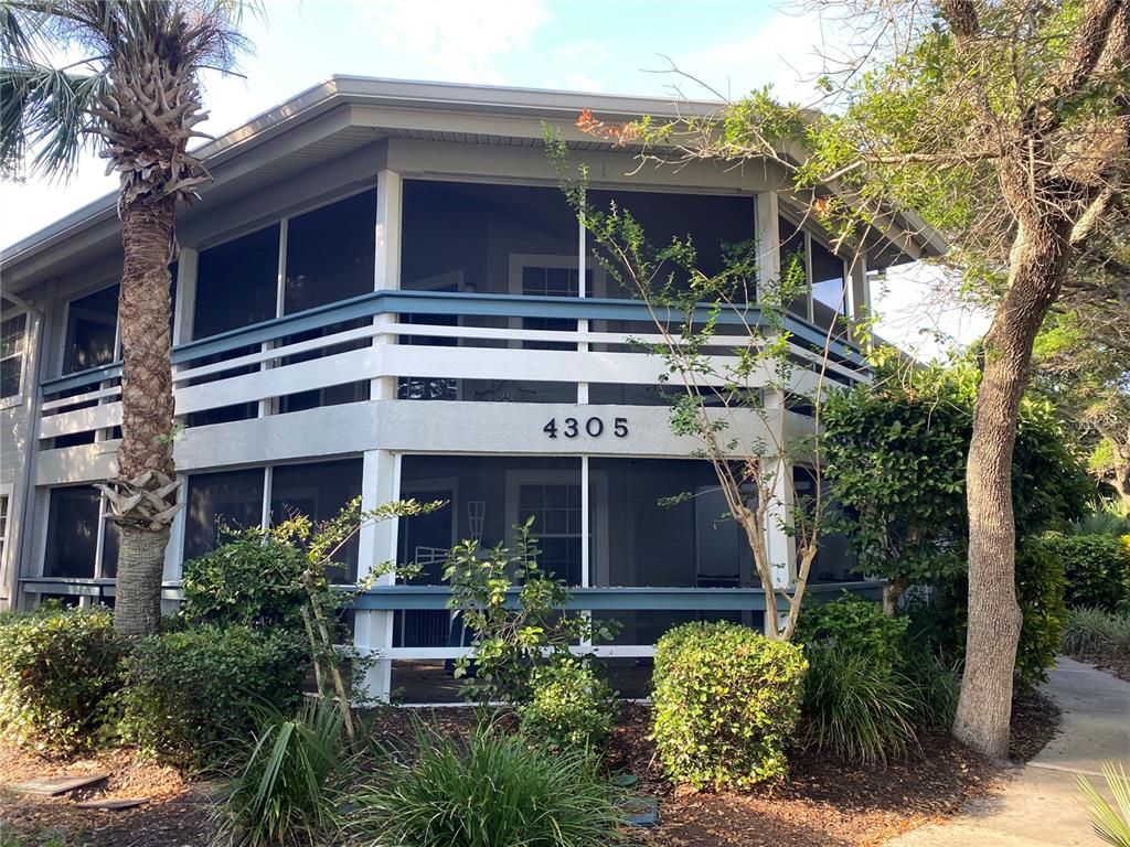 a front view of a house with plants