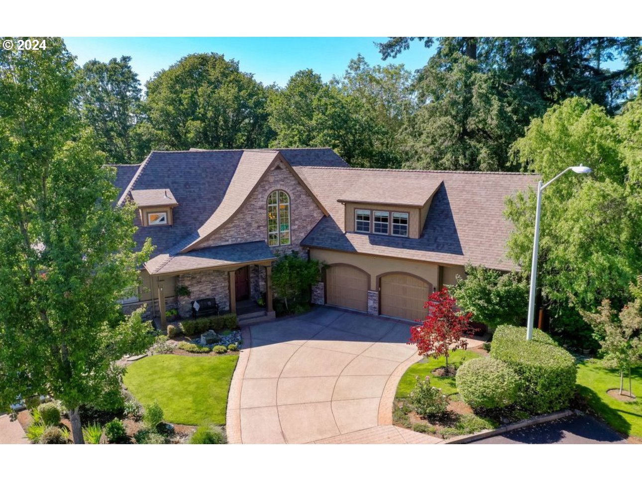 a aerial view of a house next to a yard