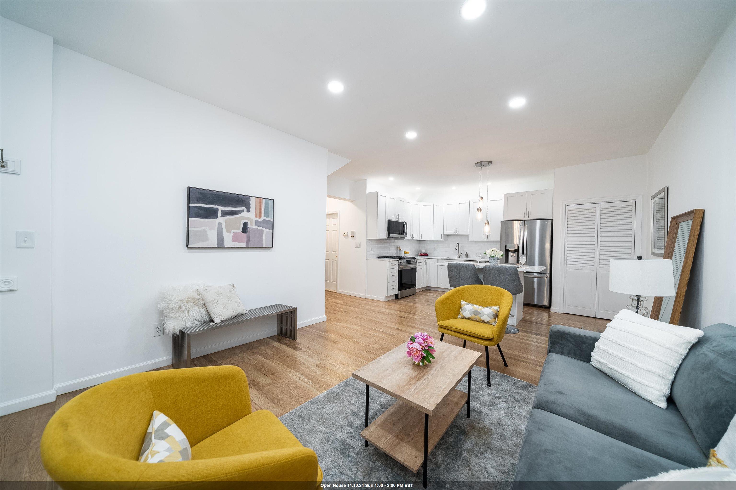 a living room with furniture and kitchen view