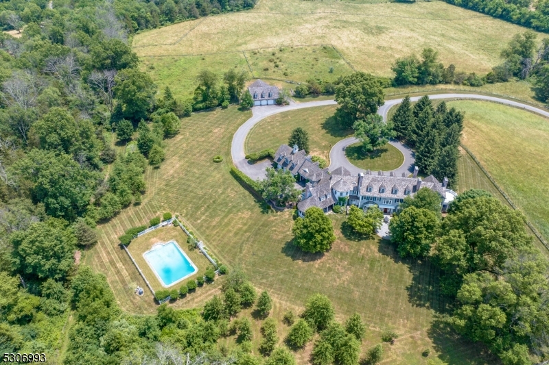 an aerial view of a house with a yard and lake view