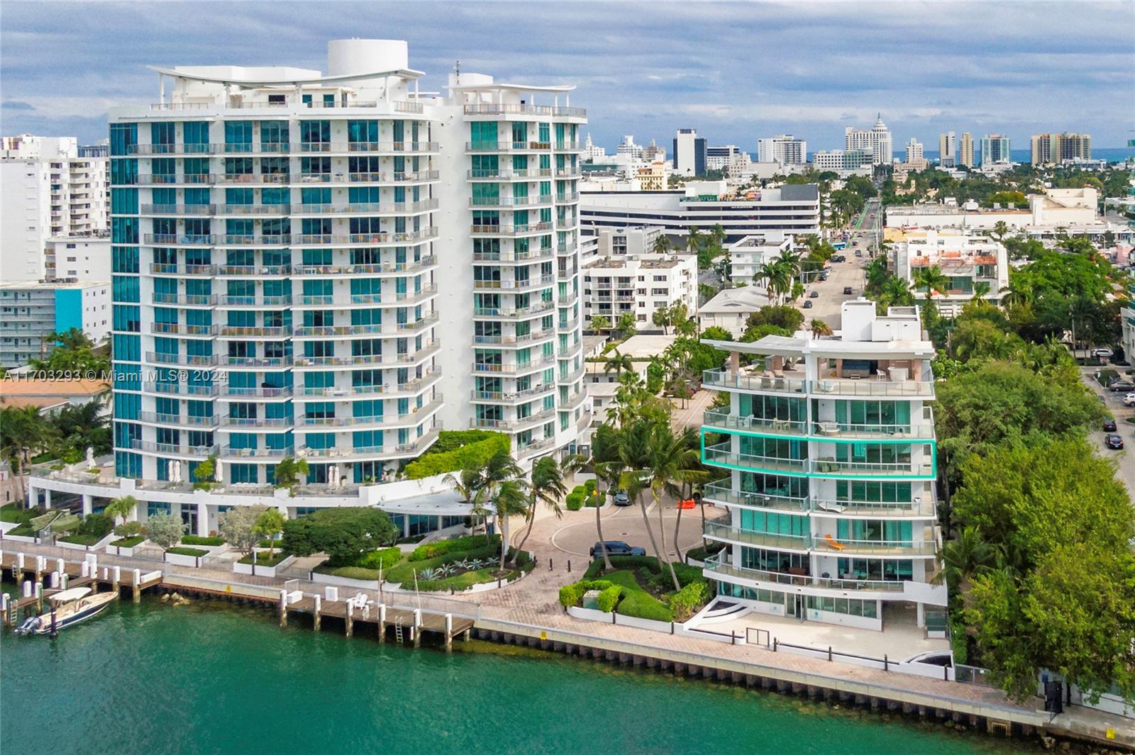 a balcony with tall buildings and trees in the background