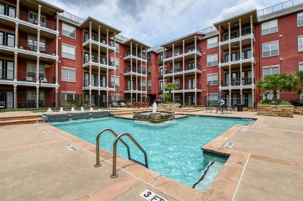 a swimming pool with outdoor seating and yard