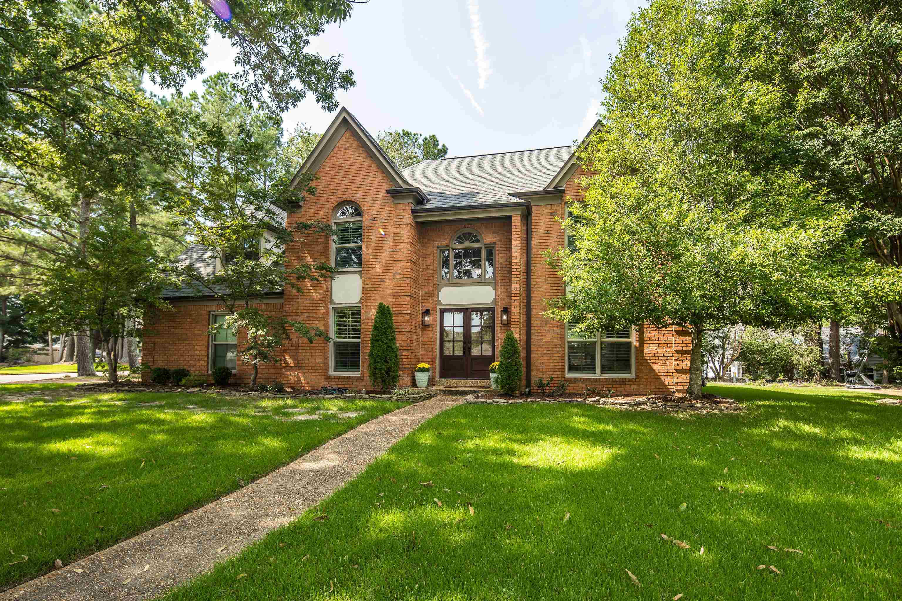 a front view of a house with a yard