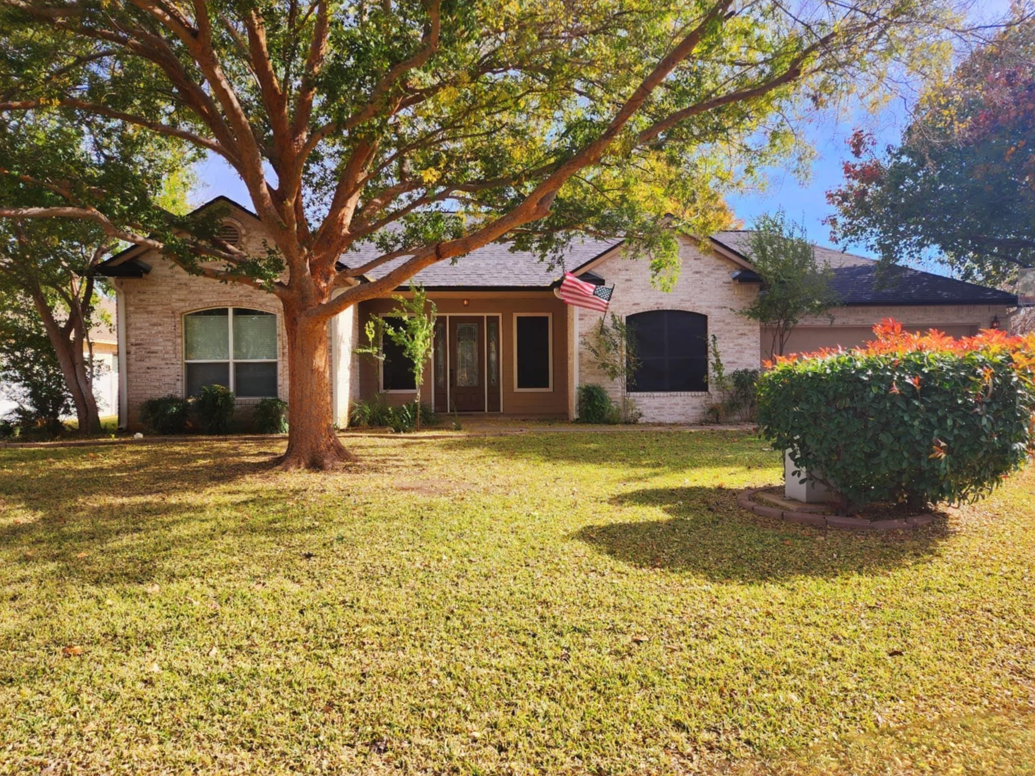 a front view of a house with a yard garage and outdoor seating