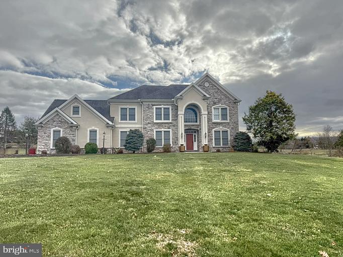 a front view of a house with a garden