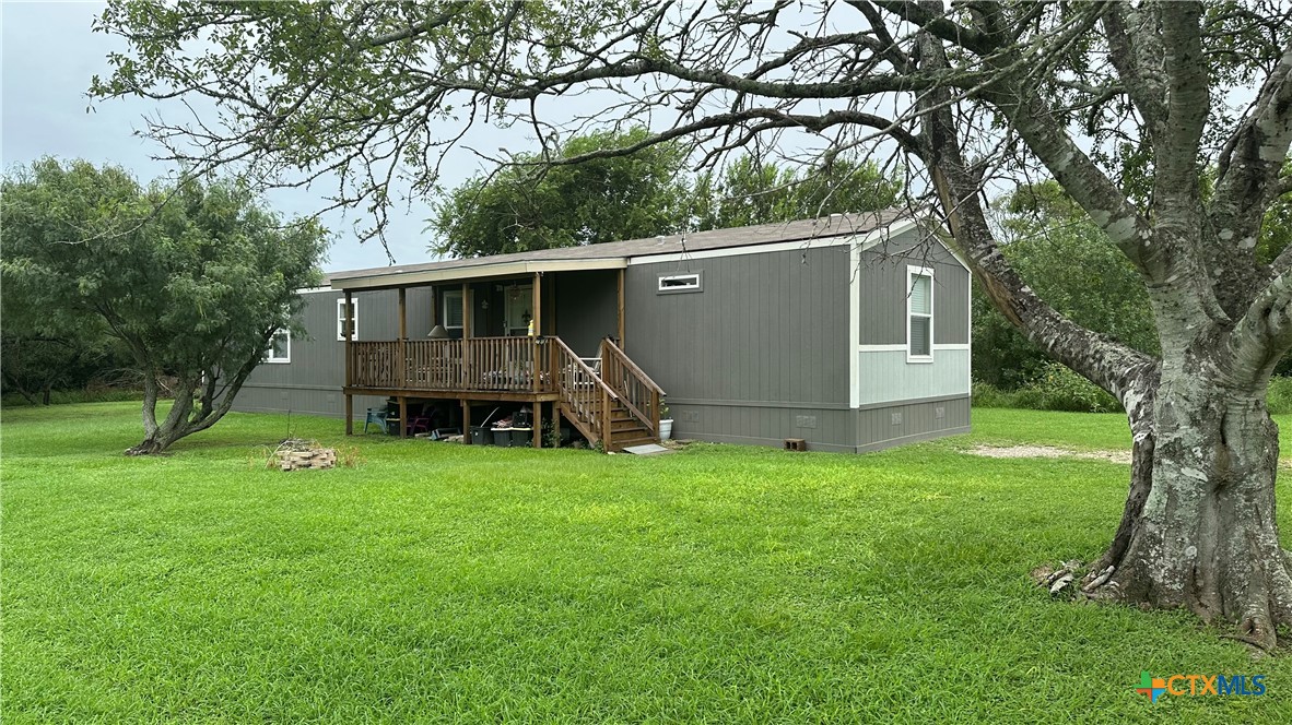 a view of a house with a backyard