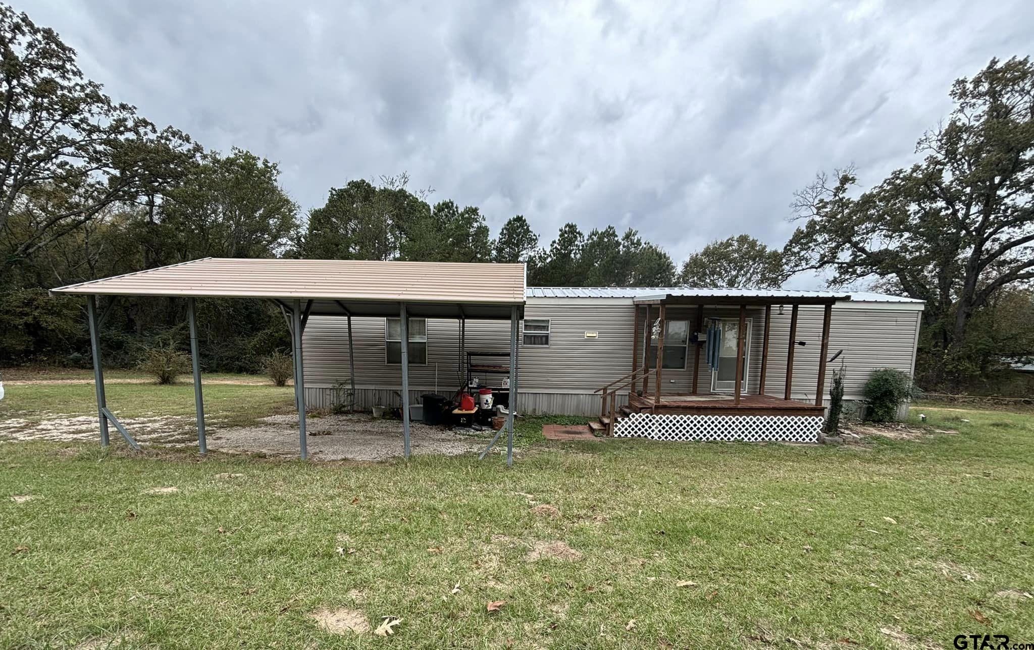 a view of a house with backyard and porch