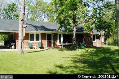 a view of a house with backyard porch and sitting area