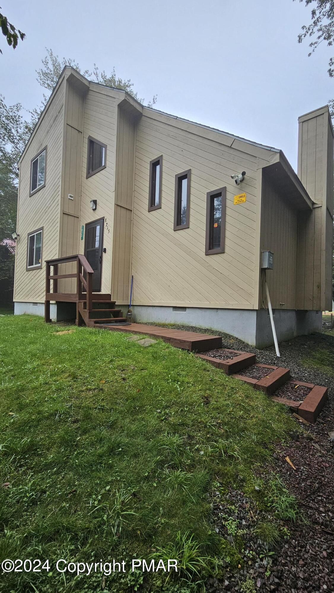 a backyard of a house with table and chairs