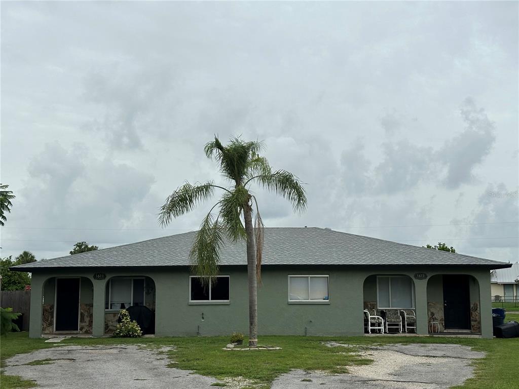 a front view of a house with a garden and yard