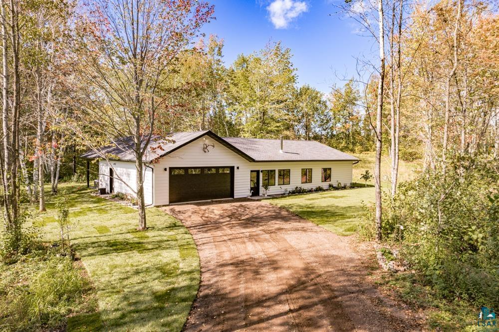 Ranch-style home with a front lawn and a garage