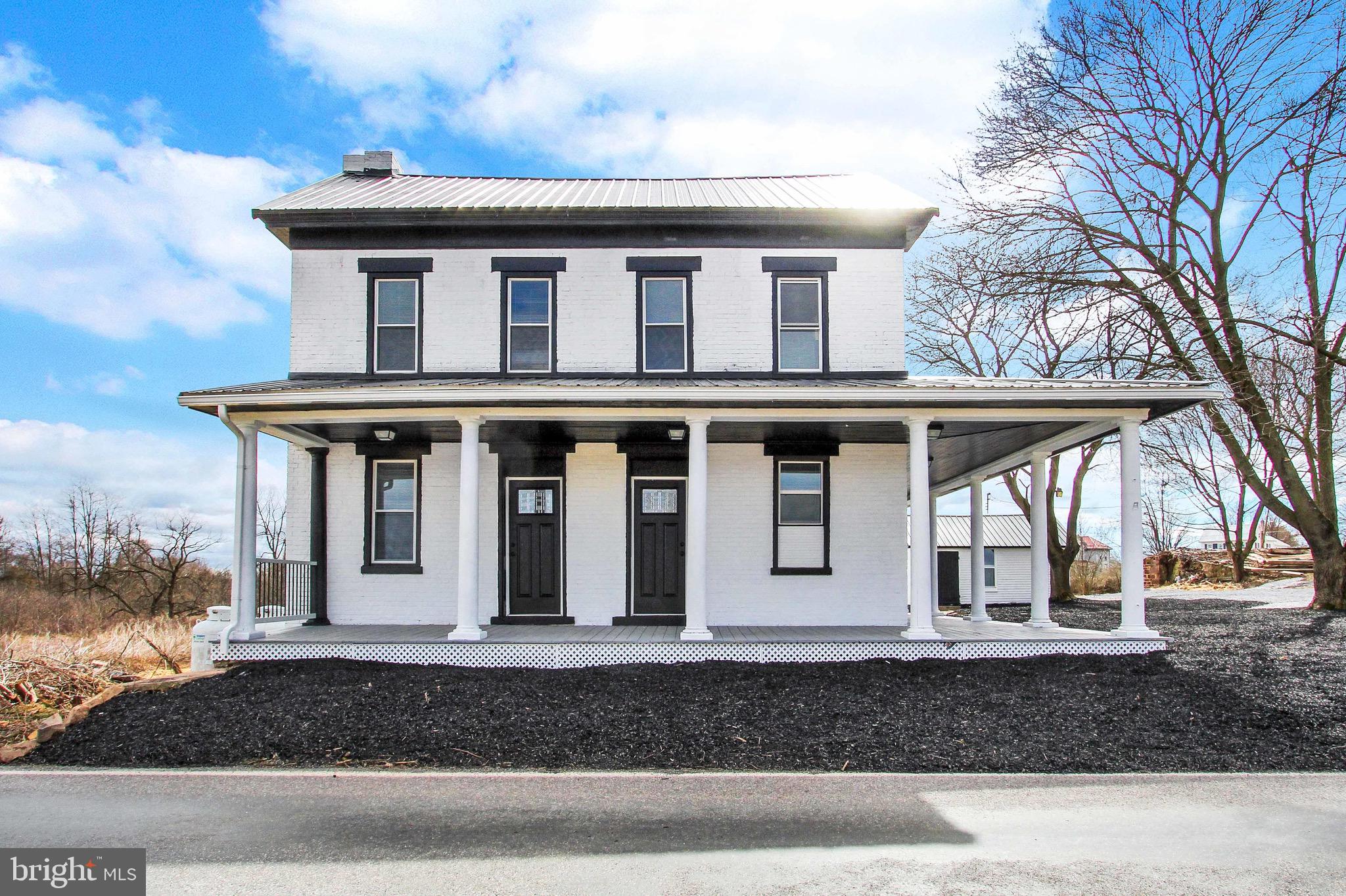 a front view of a house with garage