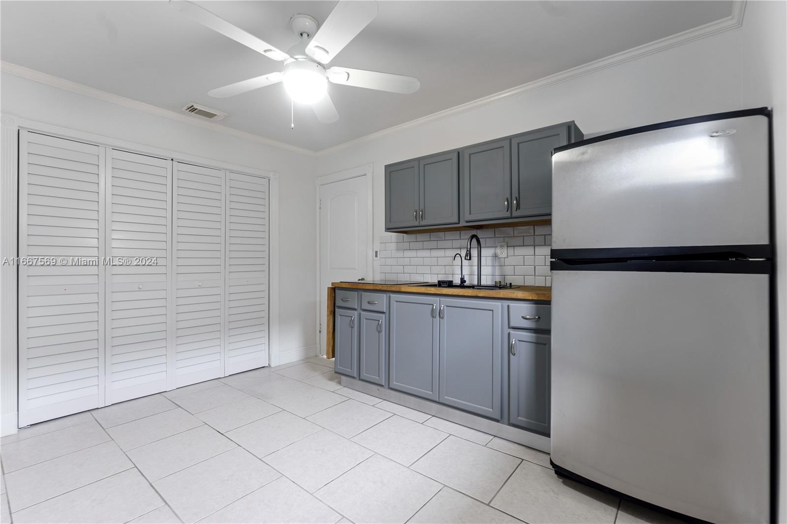 a kitchen with a refrigerator and a sink