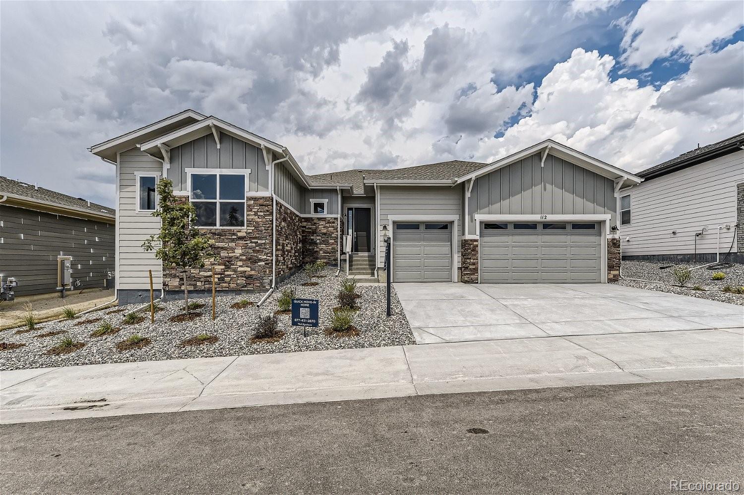 a front view of a house with garage