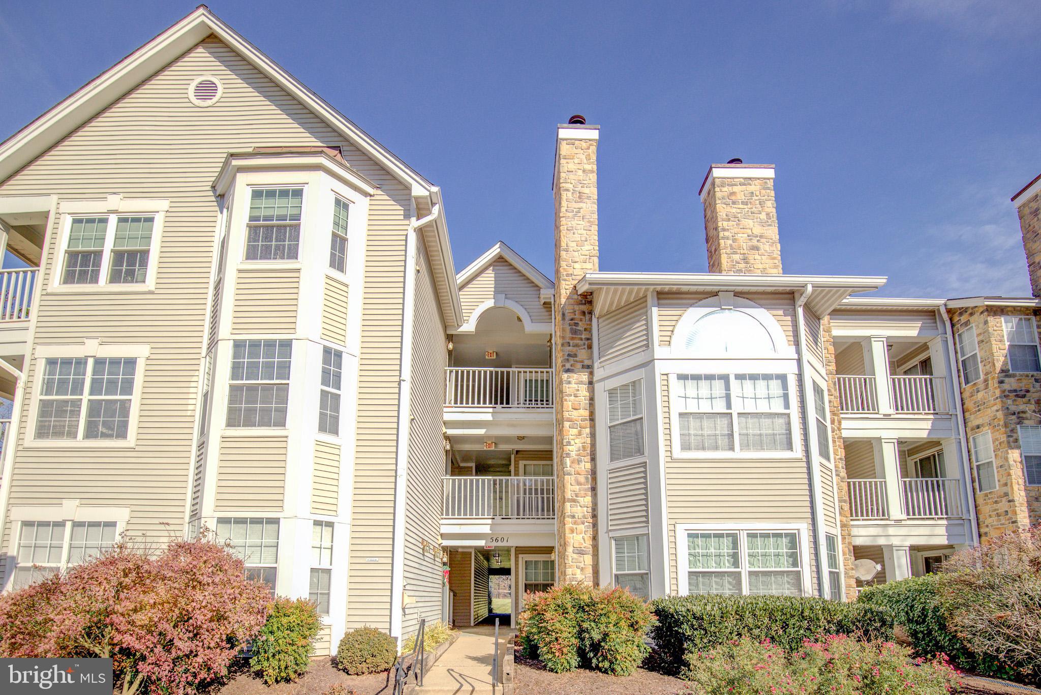 a front view of a residential apartment building with a yard