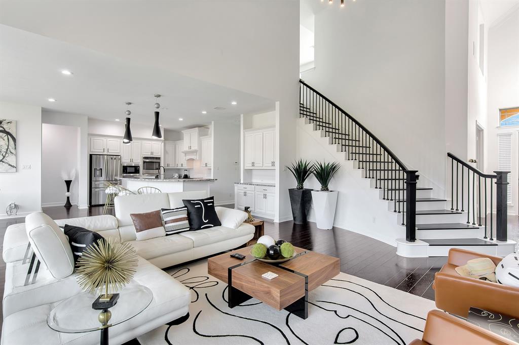 a living room with furniture kitchen and a view of kitchen