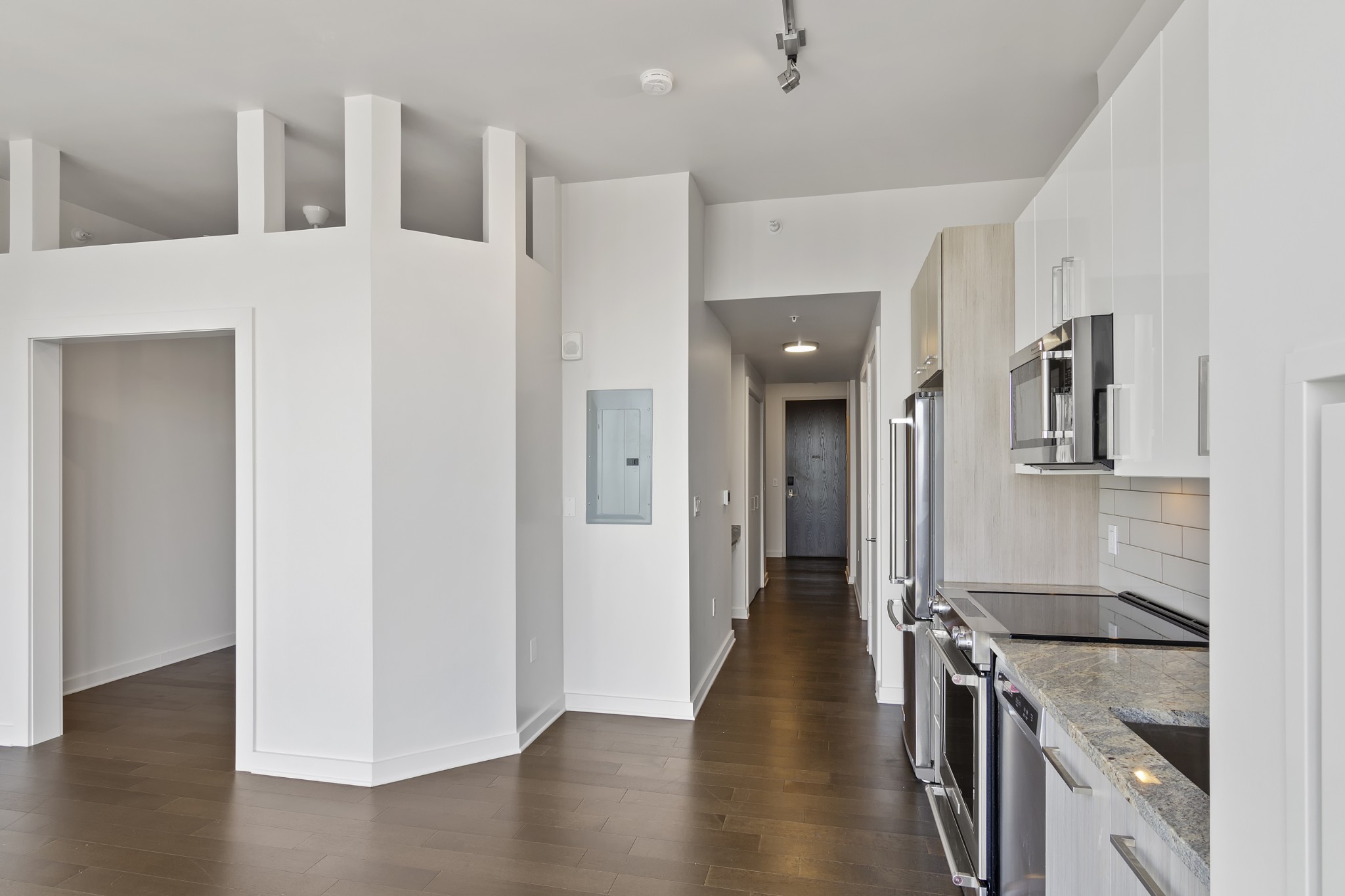 a kitchen with granite countertop a stove and a refrigerator