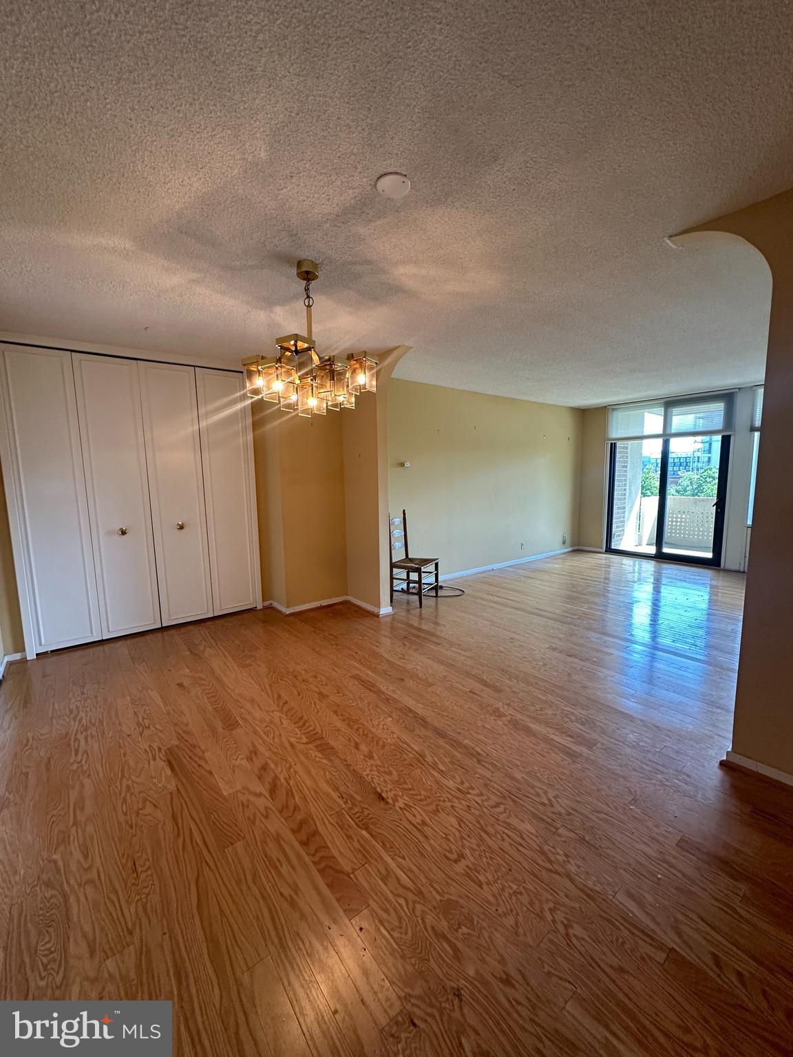 a view of a room with wooden floor