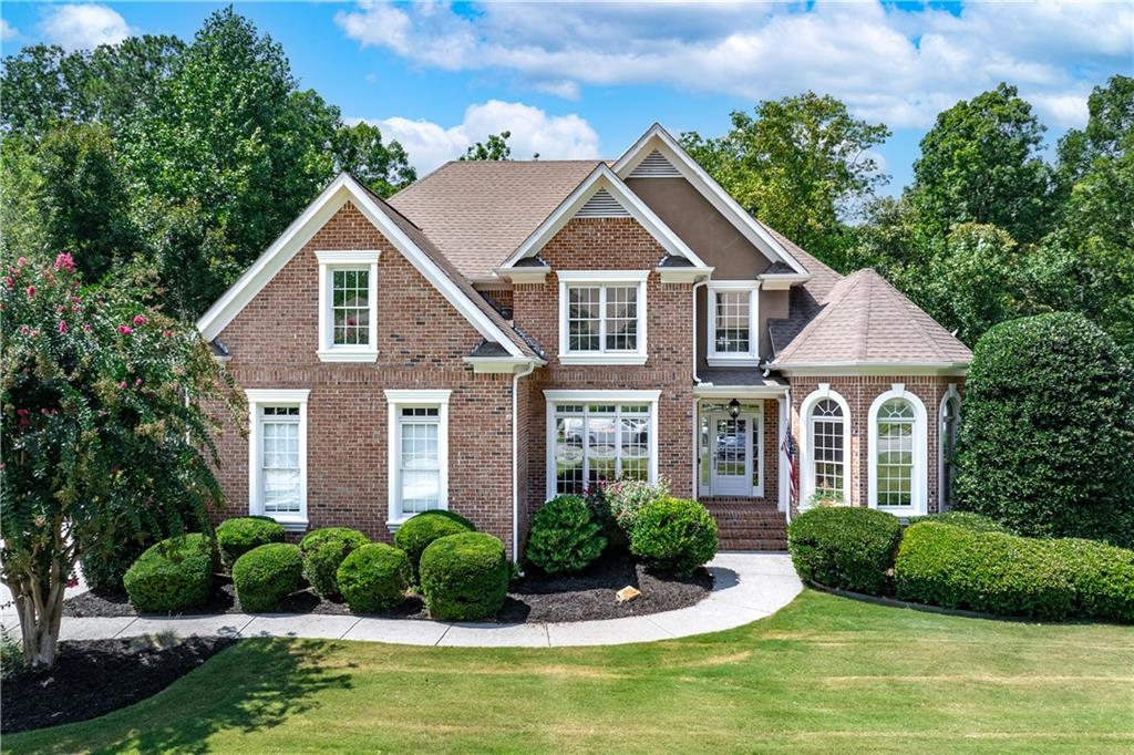 a front view of a house with a yard