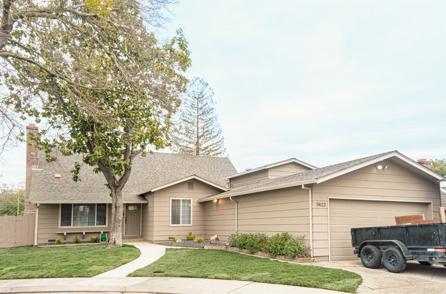 a view of a yard in front view of a house