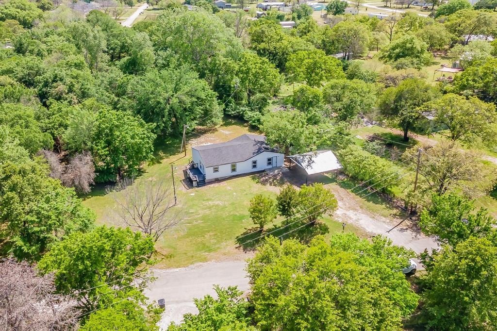 an aerial view of a house with yard swimming pool and outdoor seating