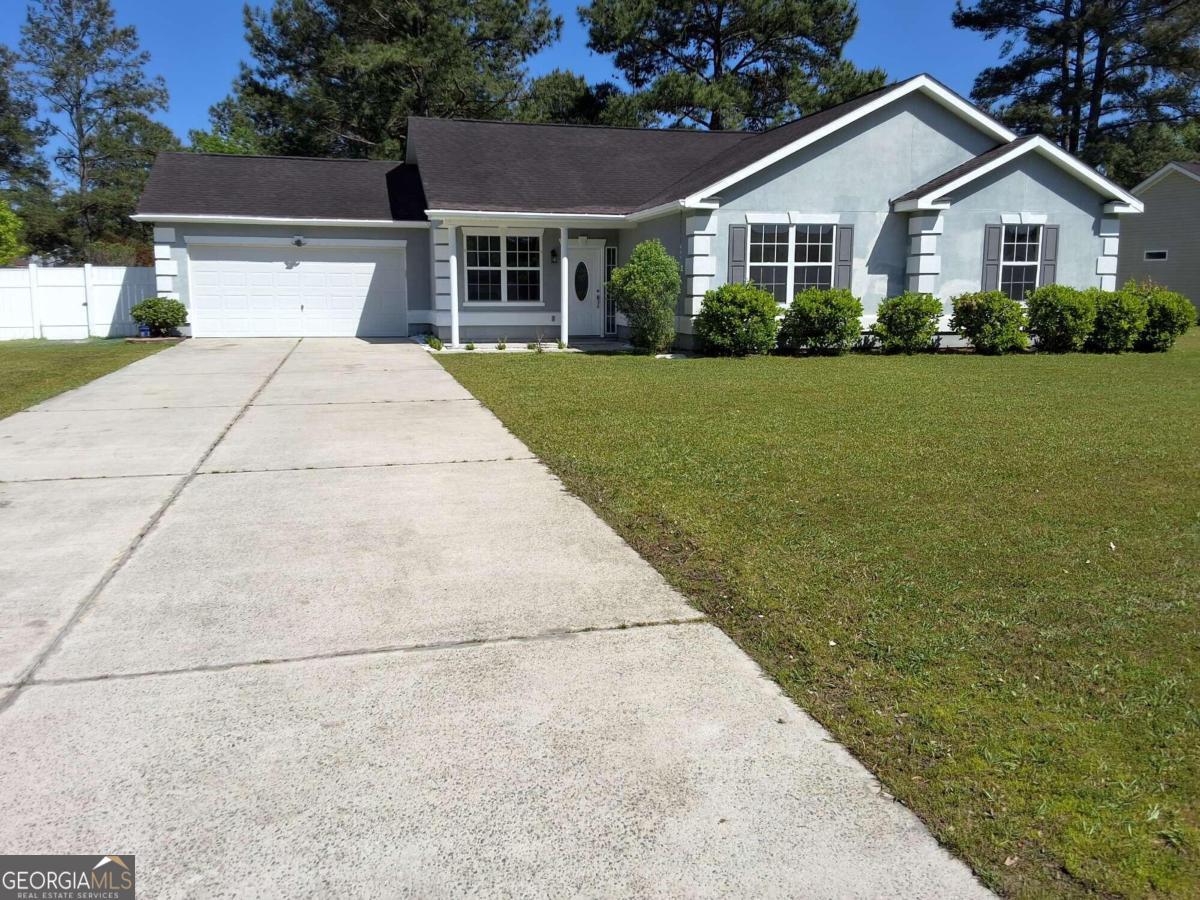 a view of house with yard and green space