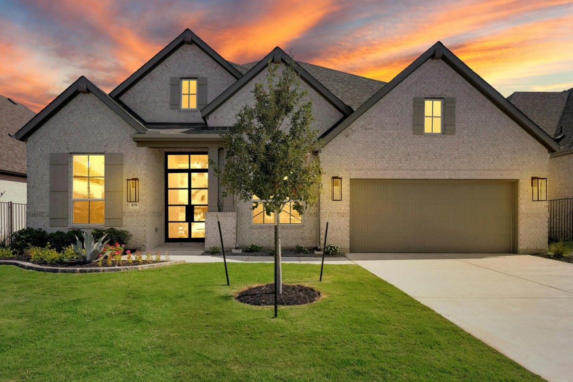 a front view of a house with a yard