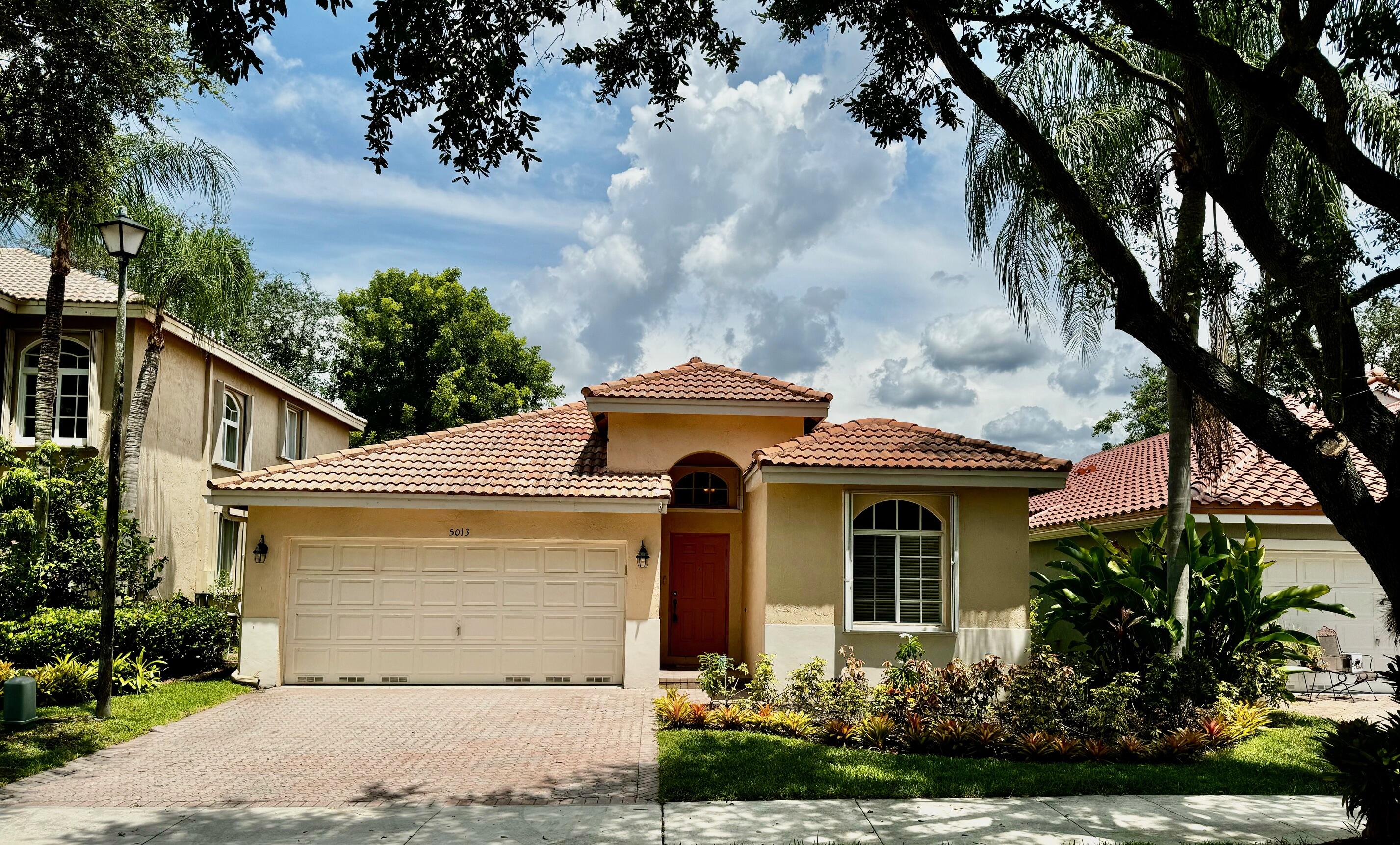 a front view of a house with garden