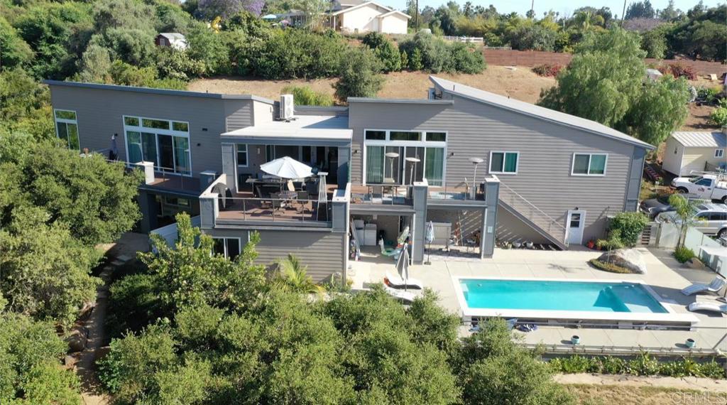 a view of house with outdoor seating area