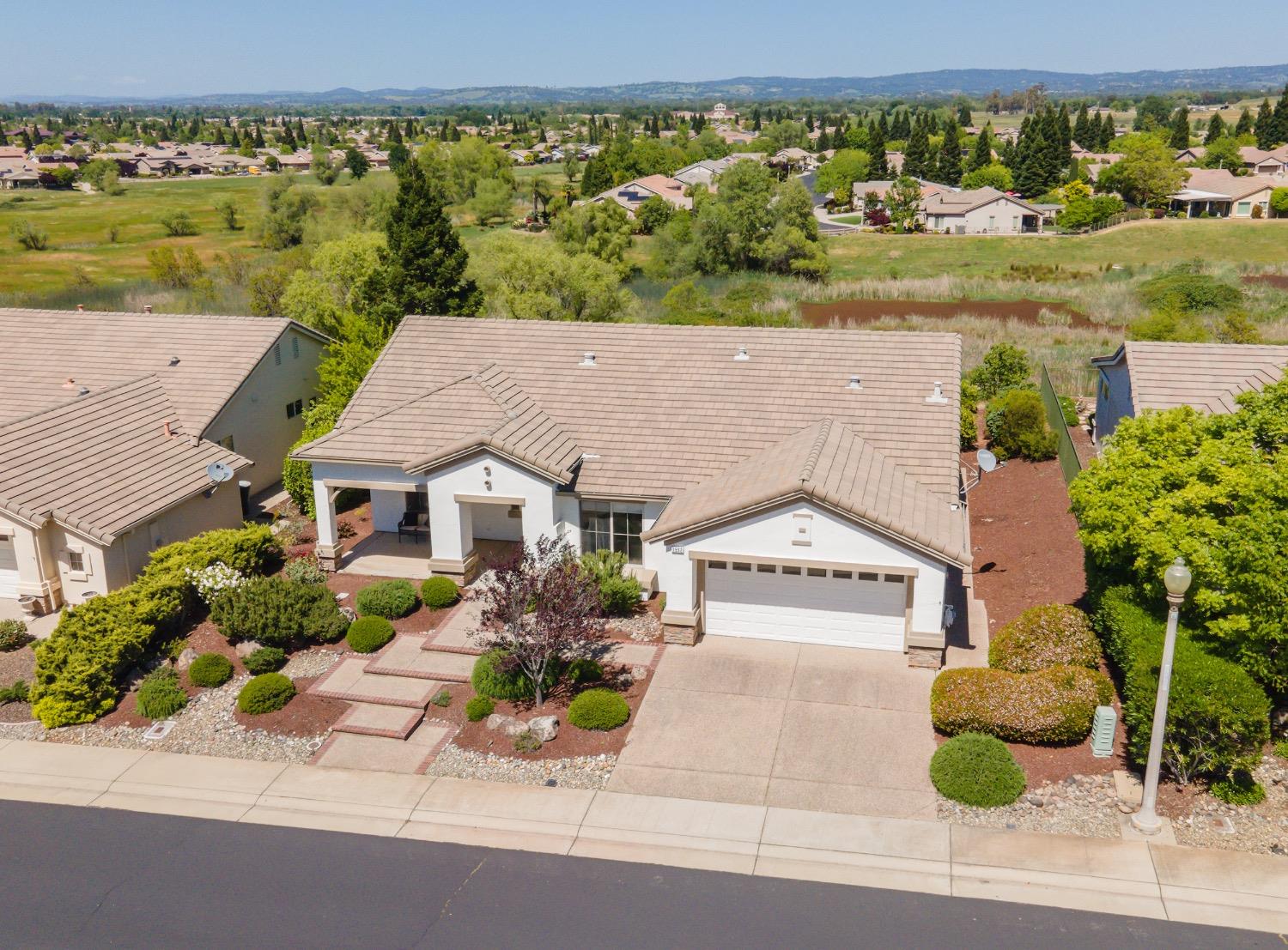 an aerial view of a house with a yard basket ball court and outdoor seating