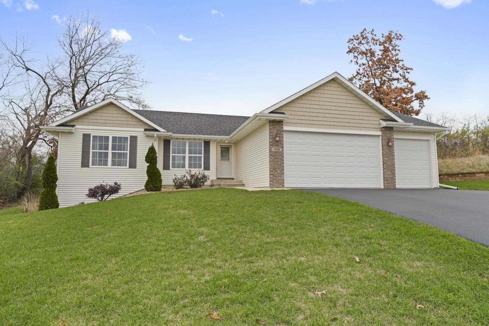 a front view of house with yard and green space